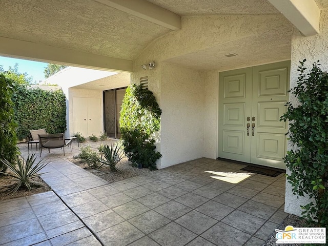 entrance to property featuring a patio area