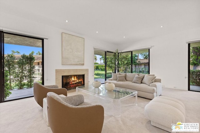 carpeted living room featuring a fireplace