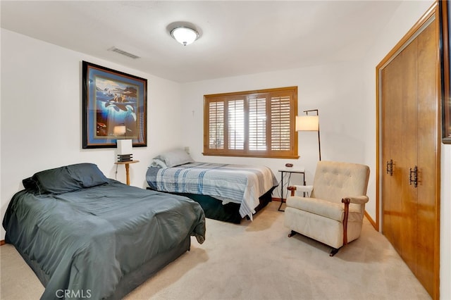 bedroom with visible vents and light colored carpet