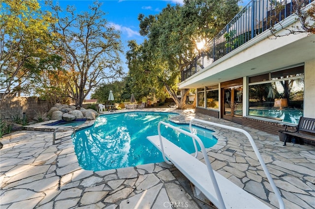 view of pool with an in ground hot tub and a patio