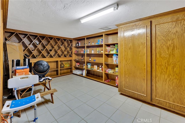 wine room featuring a textured ceiling and light tile patterned floors