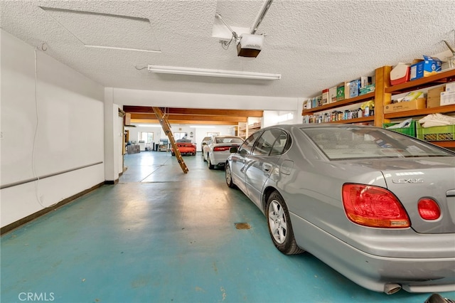 garage featuring a garage door opener and baseboards