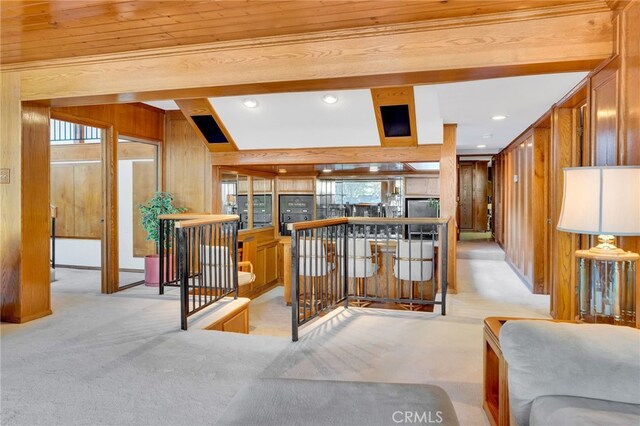 interior space with wood ceiling, wooden walls, and light colored carpet