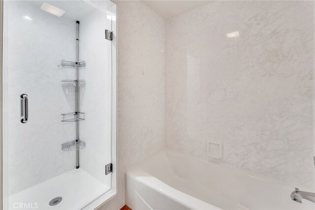 bathroom with separate shower and tub