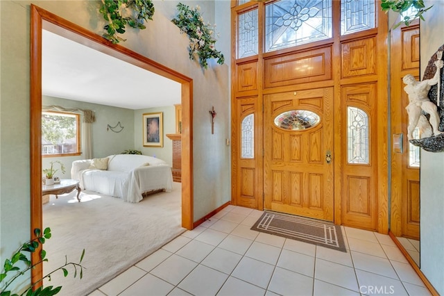 entrance foyer featuring light colored carpet and light tile patterned floors