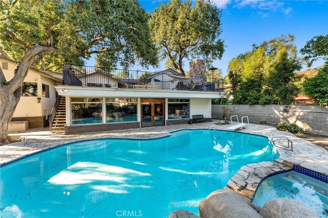 view of pool featuring an in ground hot tub and a patio