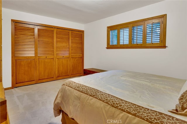 bedroom with light carpet and a closet