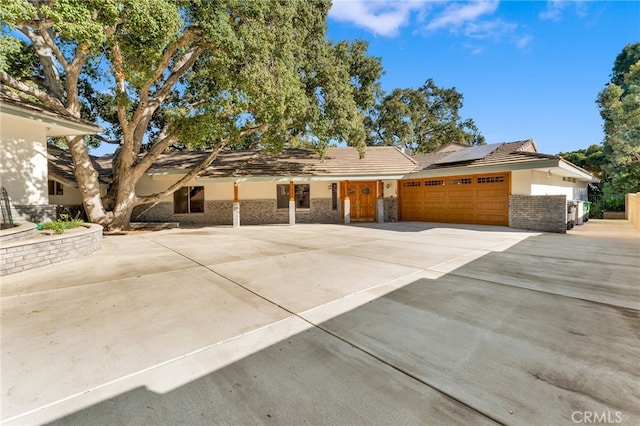 view of front of home with solar panels and a garage