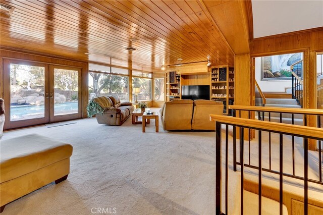 living room featuring carpet, wood ceiling, and french doors