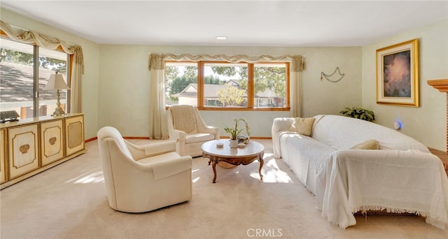 sitting room featuring baseboards and light colored carpet