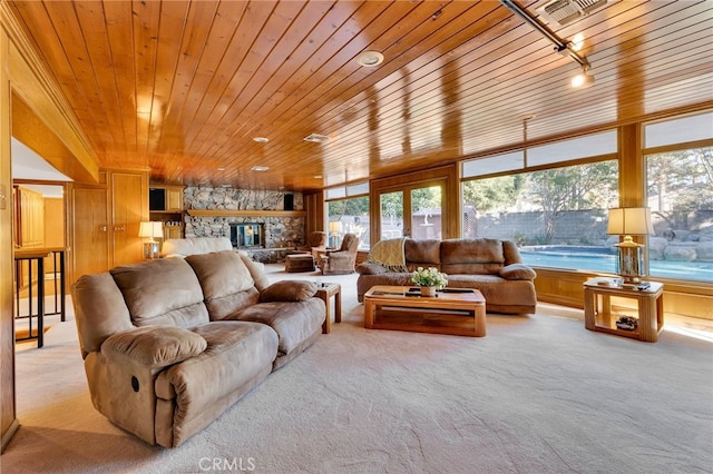 living area with light colored carpet, wood ceiling, a fireplace, and plenty of natural light