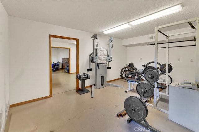 exercise room with a textured ceiling