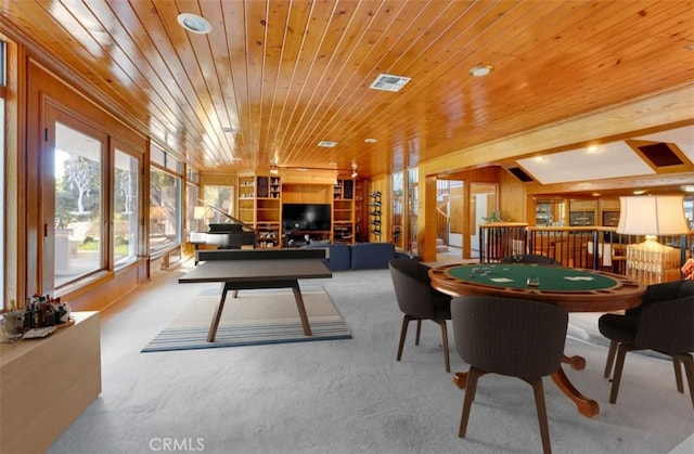 recreation room with wood ceiling, visible vents, and light carpet