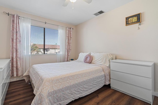 bedroom with dark hardwood / wood-style flooring and ceiling fan