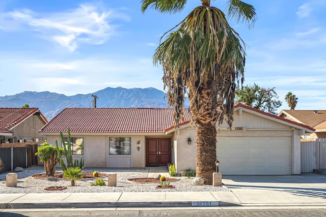 single story home featuring a mountain view and a garage