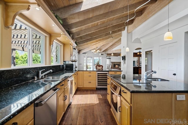 kitchen with stainless steel appliances, beverage cooler, vaulted ceiling with beams, pendant lighting, and wood-type flooring