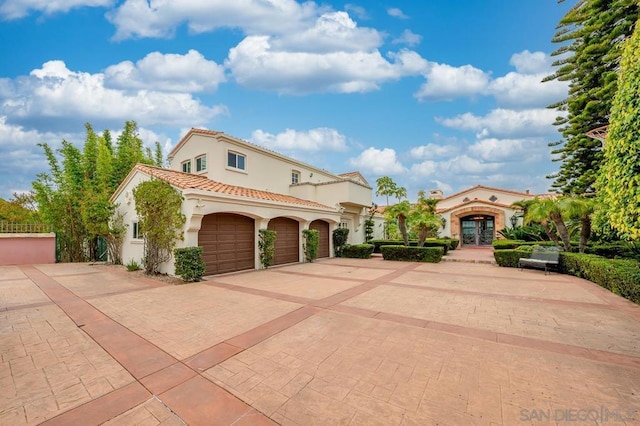 mediterranean / spanish house featuring french doors and a garage