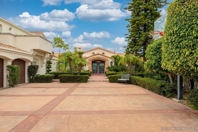 exterior space featuring french doors and a garage