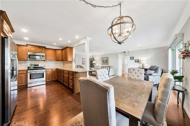 dining area featuring a chandelier, dark hardwood / wood-style floors, and ornamental molding