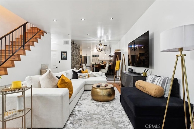 living room featuring hardwood / wood-style floors and a notable chandelier