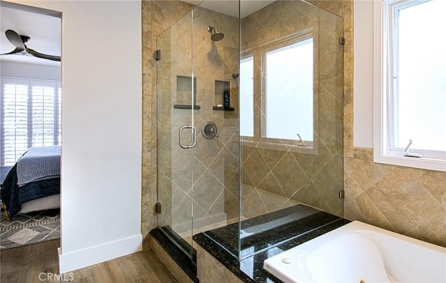 bathroom featuring hardwood / wood-style floors, ceiling fan, sink, and plus walk in shower