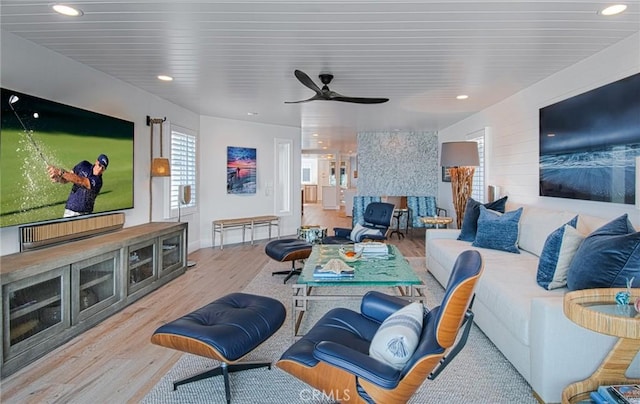 living room featuring ceiling fan and light wood-type flooring