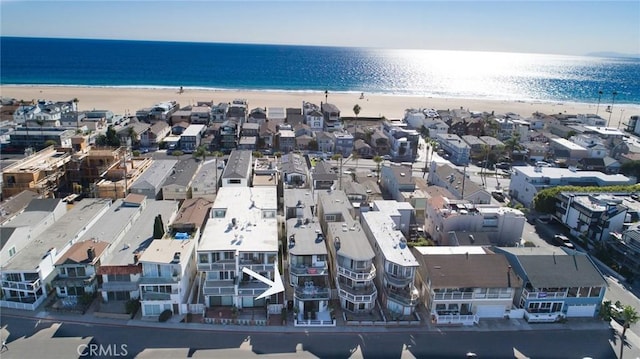 bird's eye view featuring a view of the beach and a water view