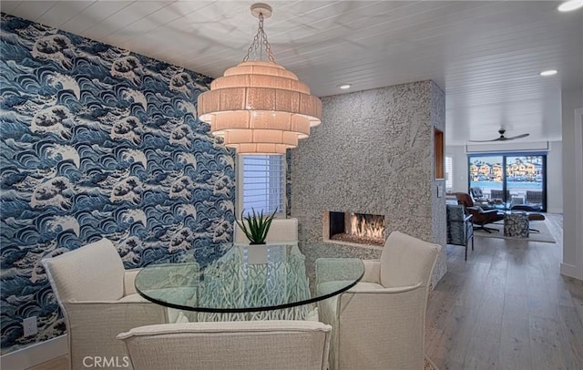 dining area with a fireplace, hardwood / wood-style flooring, ceiling fan, and wooden ceiling