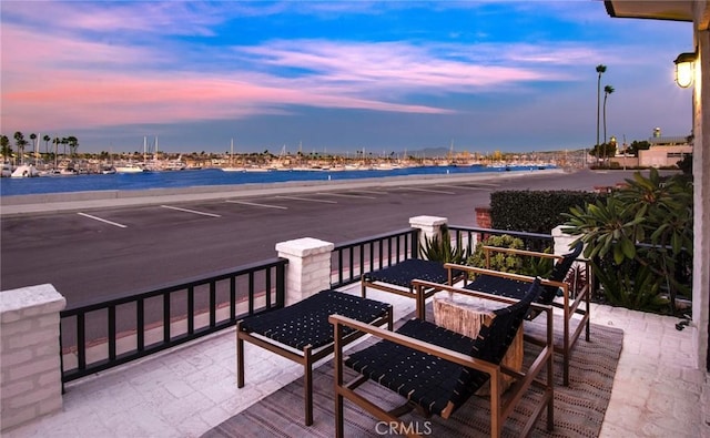 patio terrace at dusk with a water view