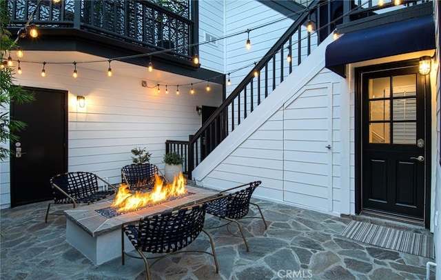 view of patio / terrace with a balcony and a fire pit