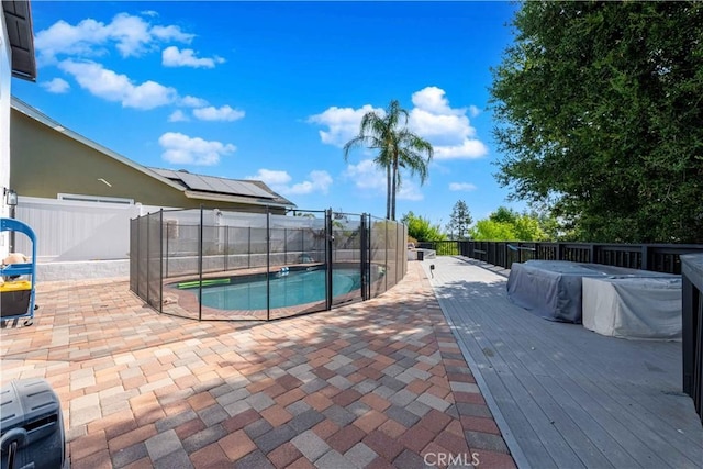 view of swimming pool with a jacuzzi and a deck