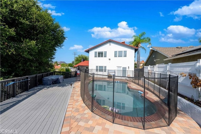 back of house with a pool side deck and a patio area