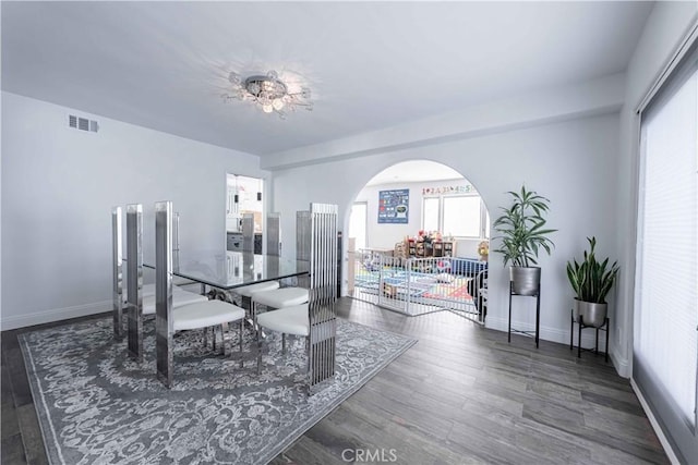 dining space featuring dark wood-type flooring