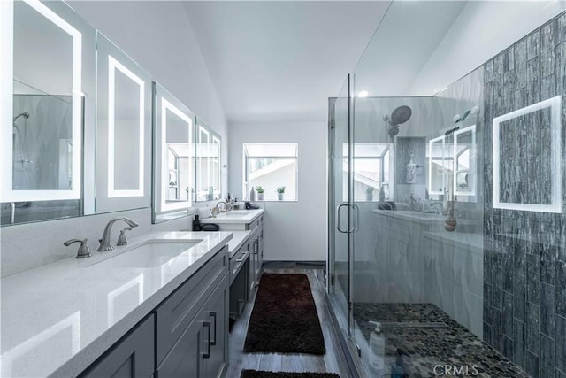 bathroom featuring vanity, an enclosed shower, and lofted ceiling