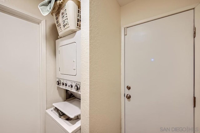 washroom with stacked washer and clothes dryer