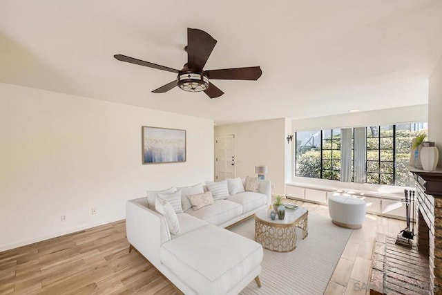 living room with light hardwood / wood-style flooring and ceiling fan