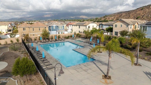 view of swimming pool featuring a mountain view and a patio area