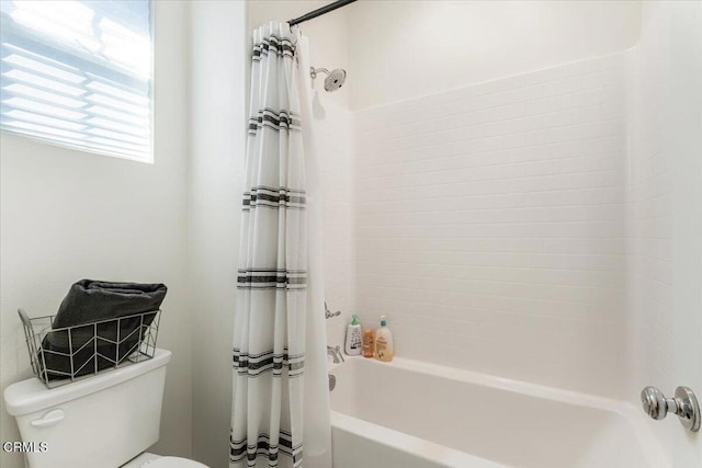 bathroom with shower / bath combo and toilet