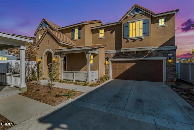 view of front of home featuring a porch and a garage