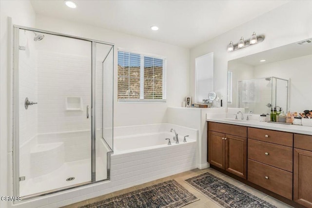 bathroom with tile patterned flooring, vanity, and separate shower and tub