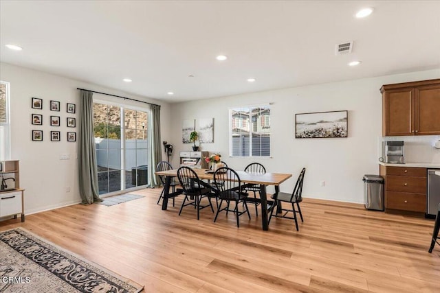 dining space with light hardwood / wood-style flooring