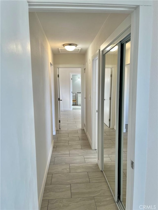 corridor with light wood-type flooring