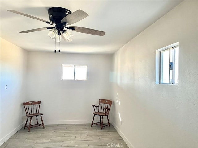 living area featuring ceiling fan