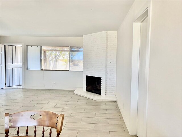 living room with a brick fireplace