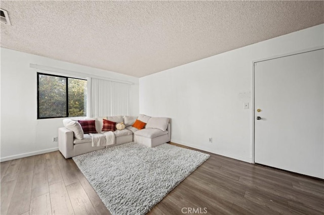 living room featuring hardwood / wood-style floors and a textured ceiling