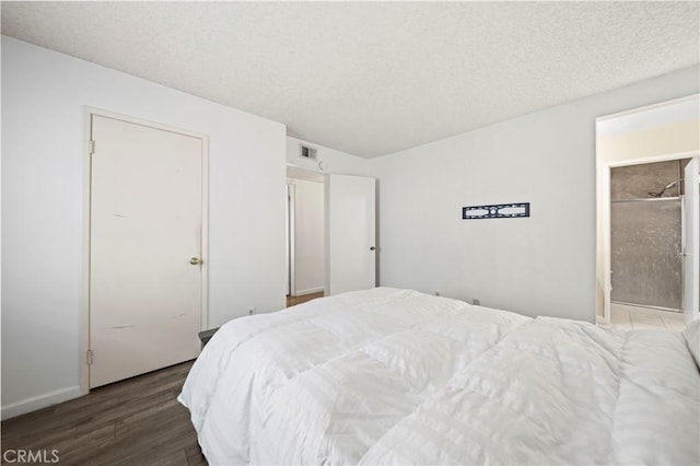 bedroom featuring dark hardwood / wood-style floors and a textured ceiling