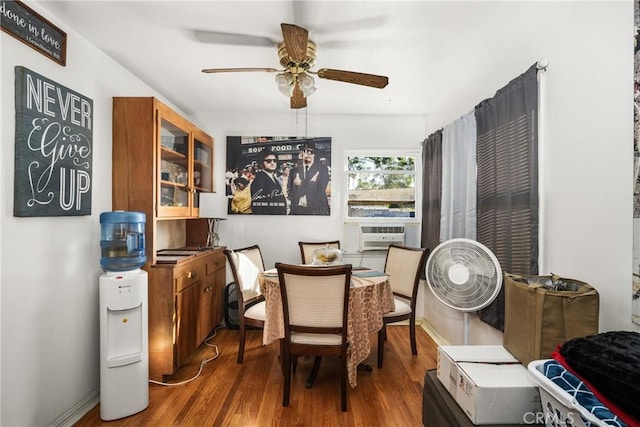 dining room with ceiling fan, cooling unit, and hardwood / wood-style flooring