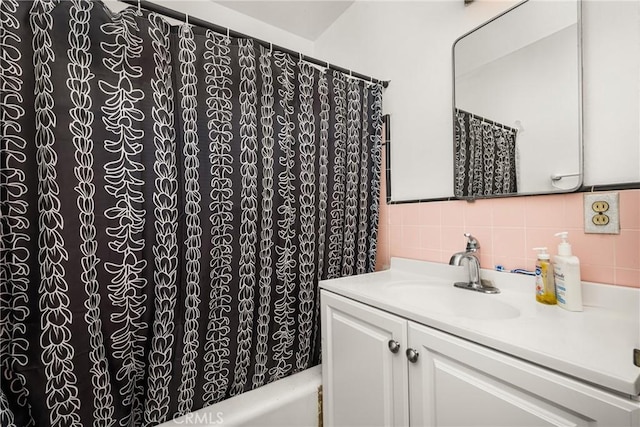 bathroom featuring tasteful backsplash and vanity