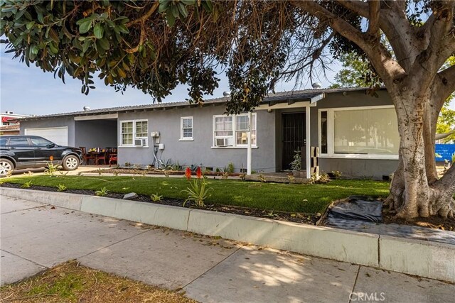 ranch-style home with a garage and a front yard