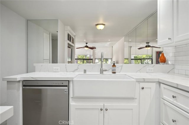 kitchen with a wealth of natural light, white cabinetry, sink, and stainless steel dishwasher